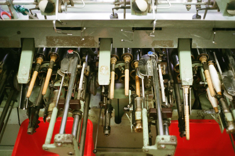 Close-up of industrial machinery inside a European weaving mill.